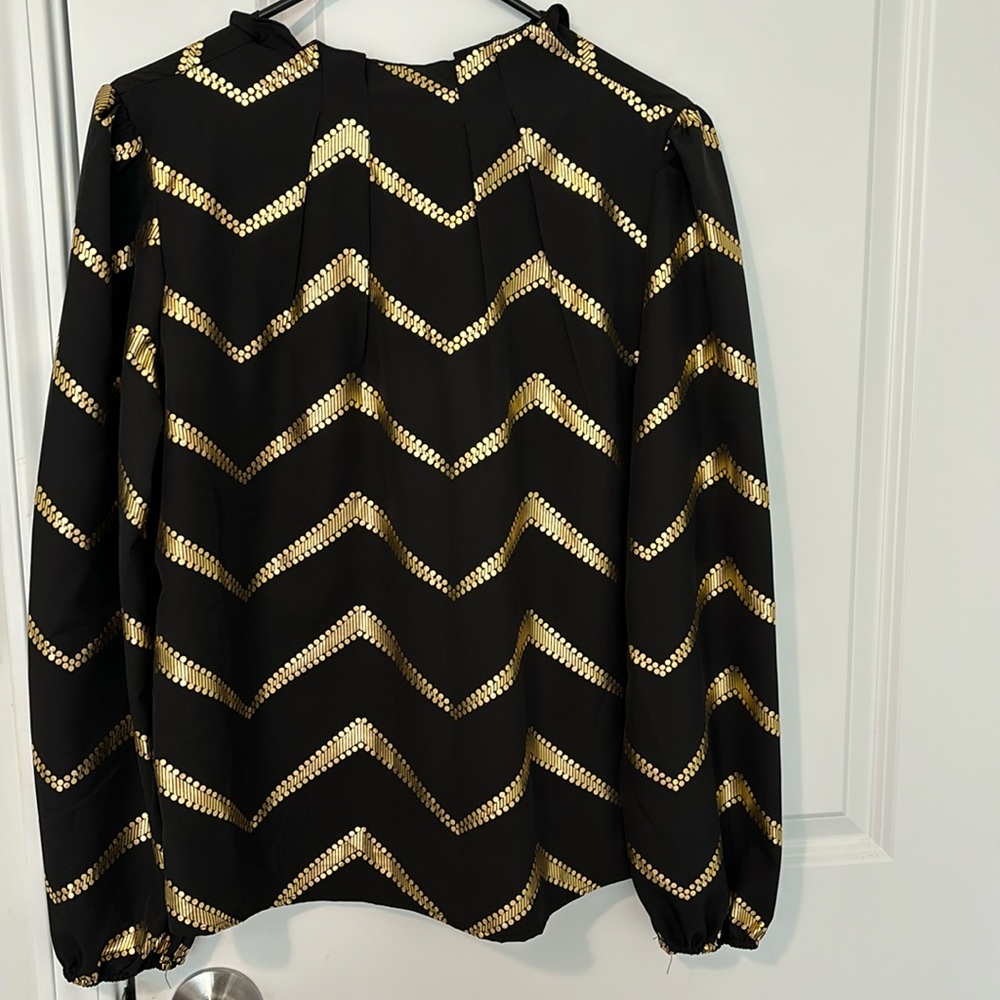 Black and gold dress top recommended for a medium build to small person